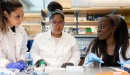 Photo of three UCSF medical students working in a lab.